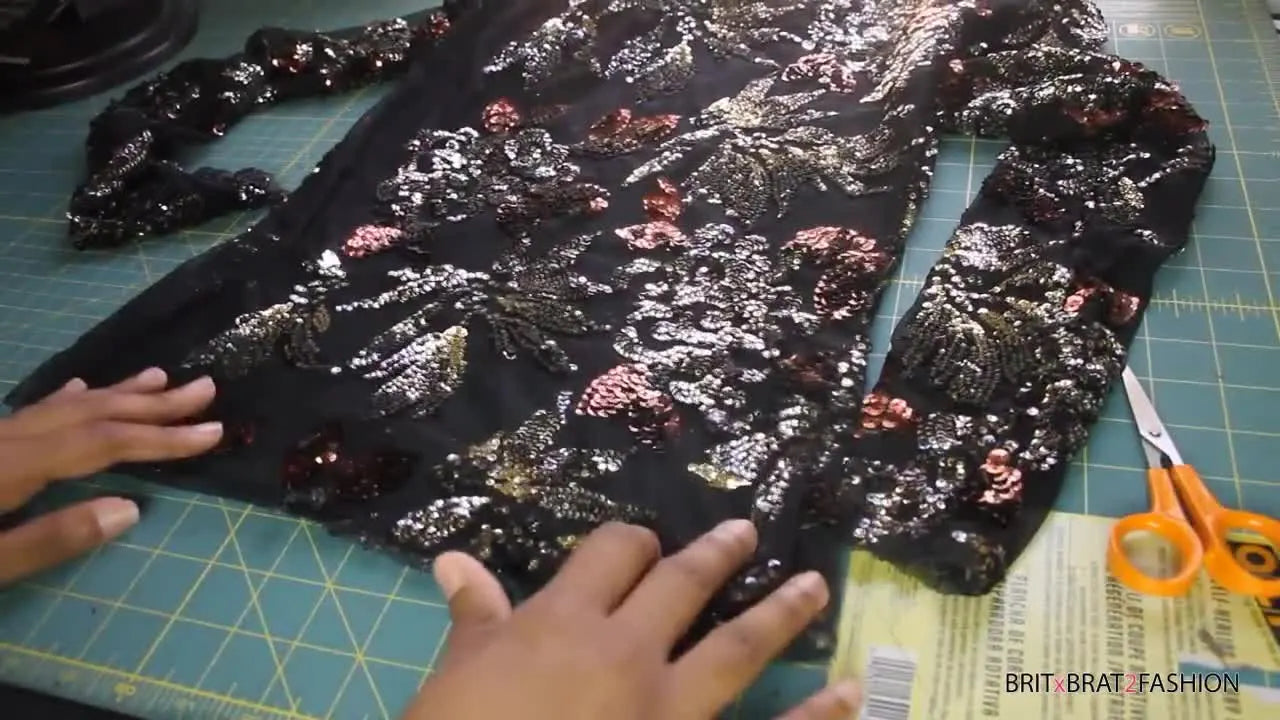Cutting around a sequin pattern with precision scissors.