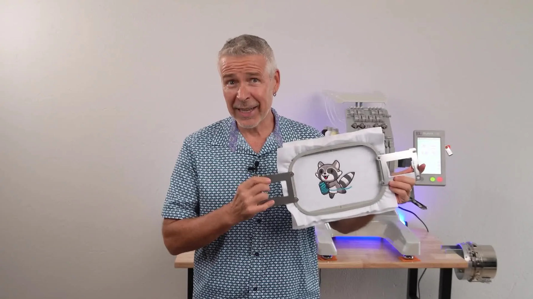 A split-screen timing test shows a smartphone stopwatch beside a multi-needle embroidery machine running the same design at its maximum speed setting.