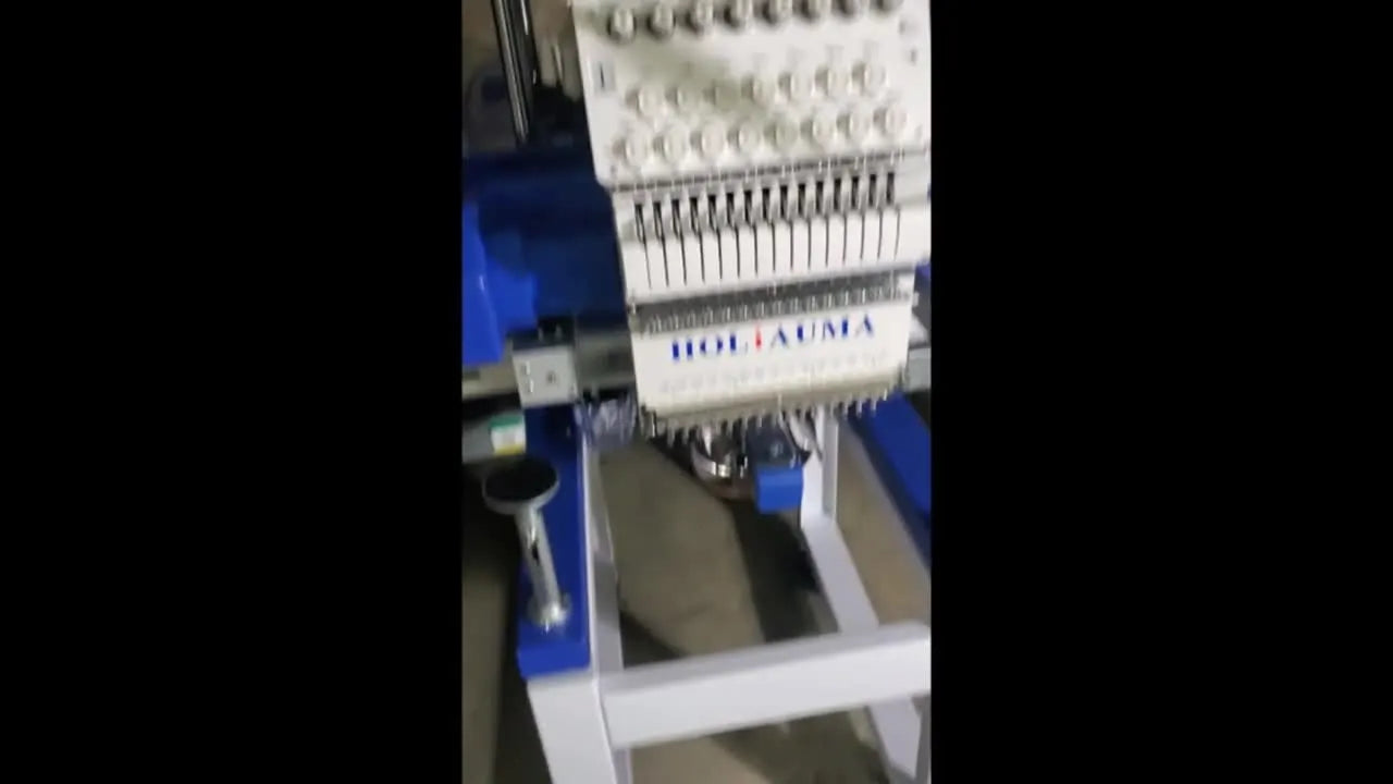 The HoliAuma machine fully revealed on its stand in a driveway at night, ready for inspection and first test stitches.