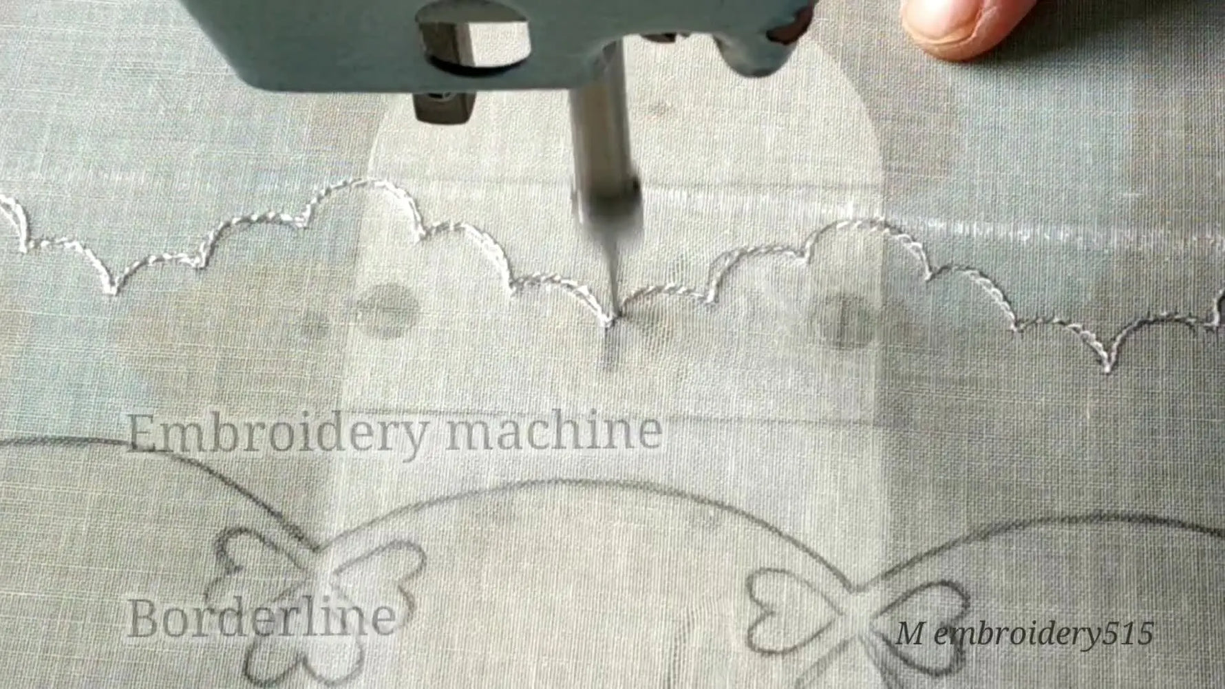 Embroidery machine needle beginning to stitch the wavy border outline on sheer fabric.