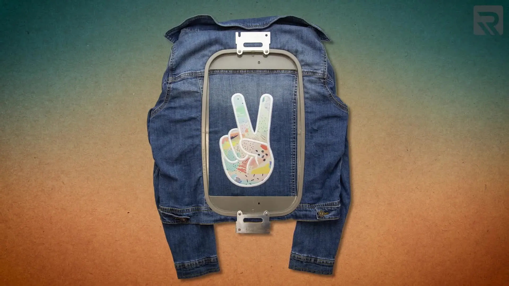 A large EM-1010 hoop mounted on a denim jacket back, showing how big designs fit when the hoop choice matches the garment.