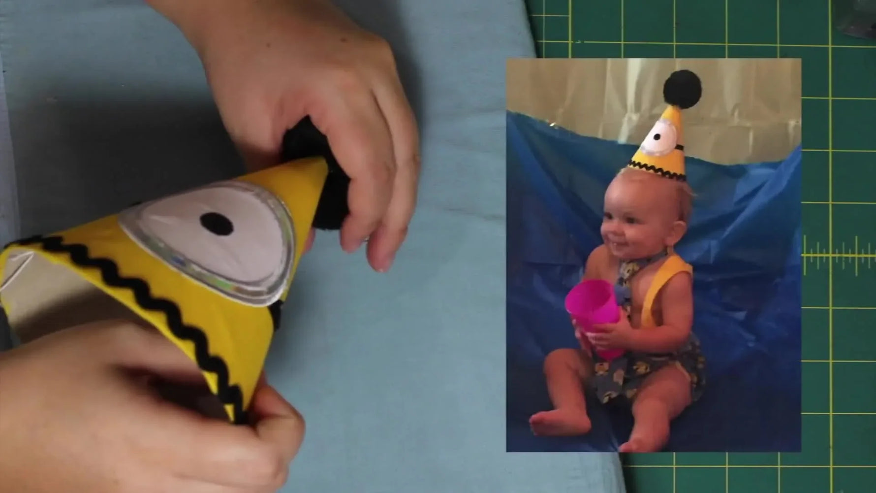 A baby models the finished yellow Minion-inspired party hat with a bold appliqué eye and a large black pom‑pom topper.