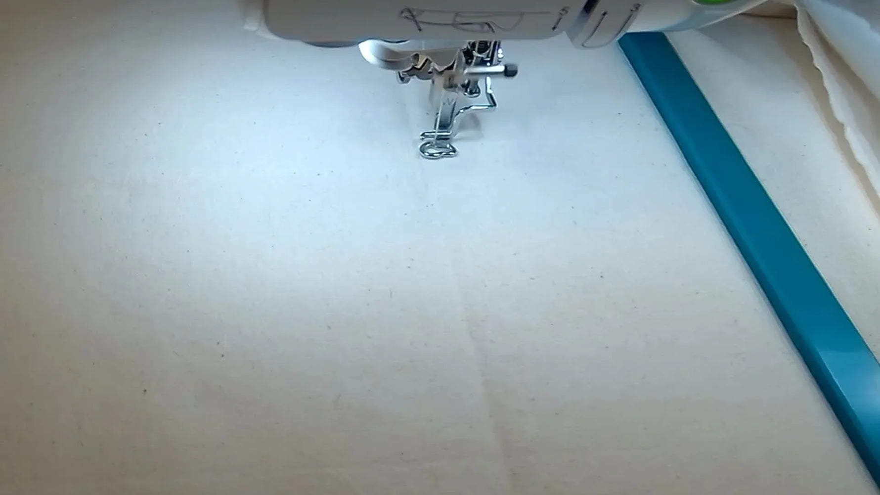 An overhead view of the leaf panel mid-stitch, showing dense yellow and red stitching inside a large magnetic hoop on the Brother Luminaire 2.