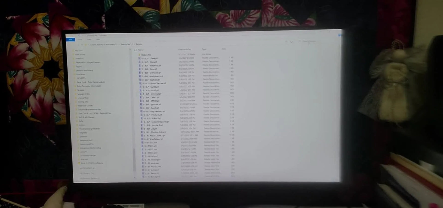 A close-up of the Baby Lock Solaris screen with a USB drive plugged into a protective extension dongle, ready to import custom decorative fills.