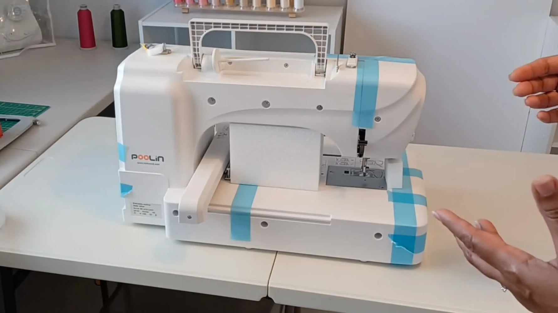 The Poolin EOC06 LCD touchscreen shows the built-in bow design selection and key machine settings before the test stitch-out.