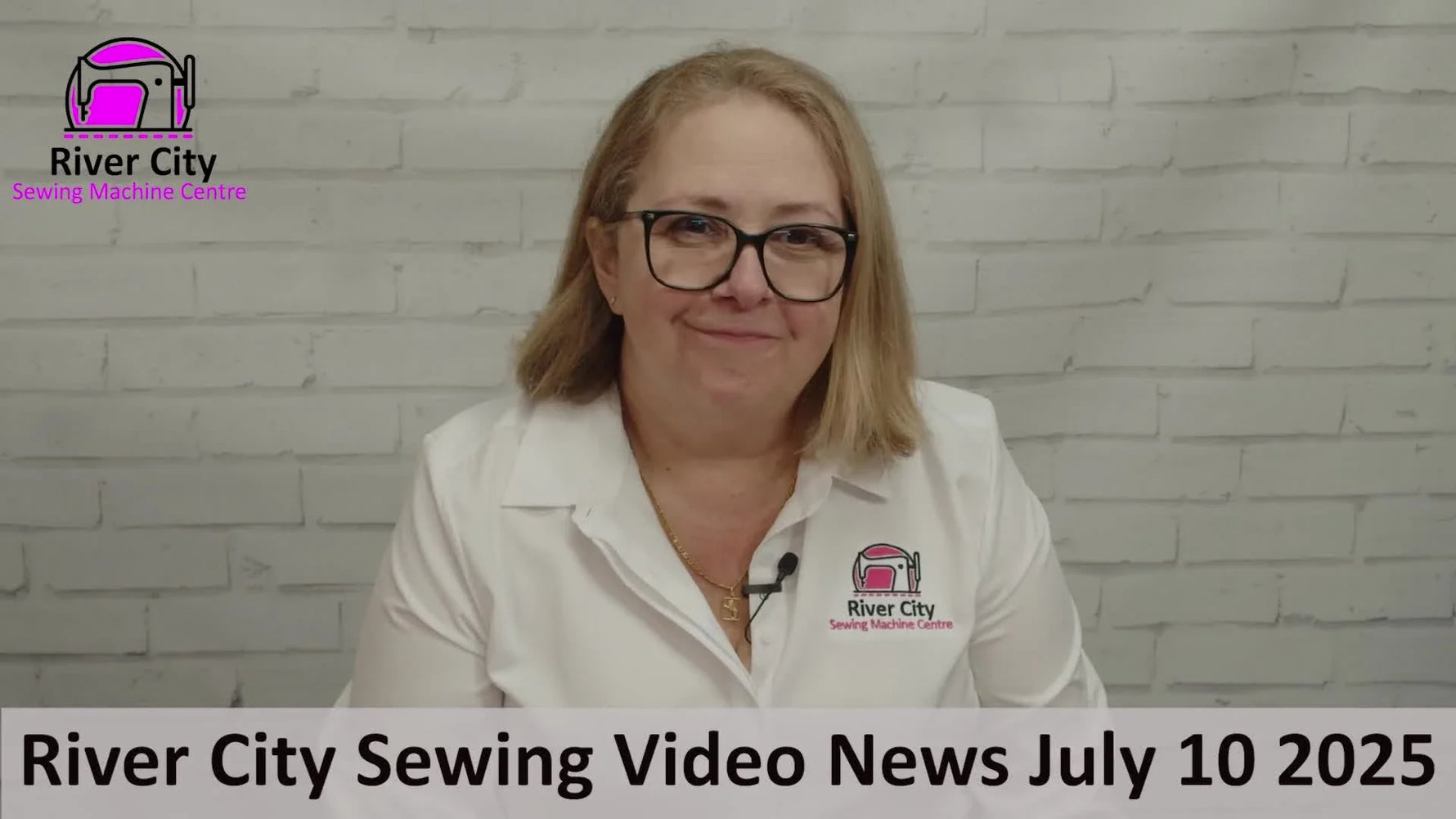 Judy from River City Sewing introduces the weekly store update from in front of a white brick wall.