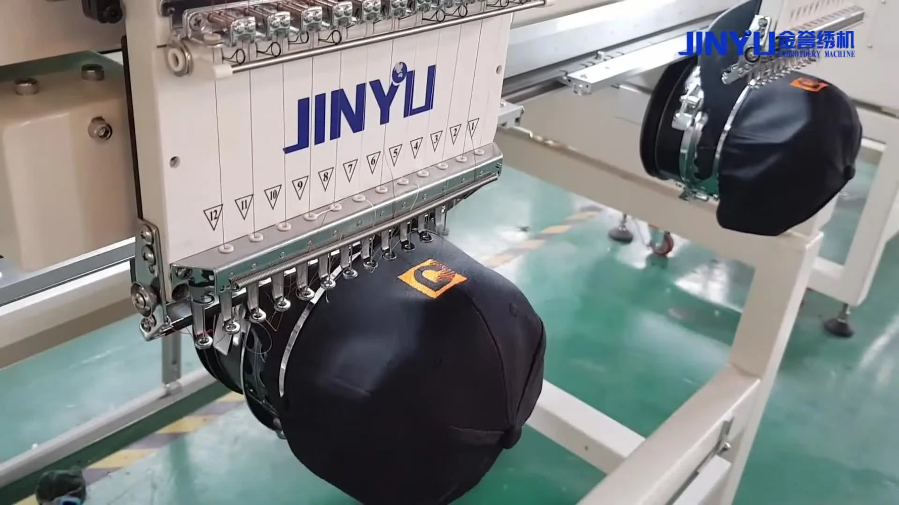 Embroidery machine actively stitching a logo onto a cap