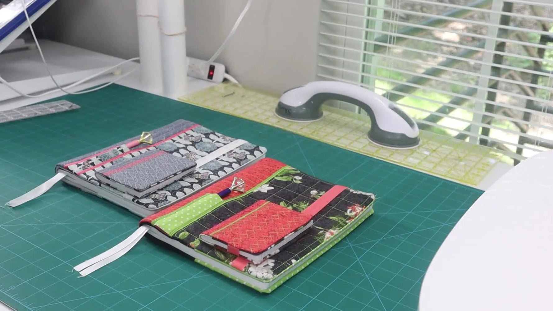 A side-by-side tabletop comparison shows the finished full-size “Mommy” cover and the matching mini “Baby” composition book cover.