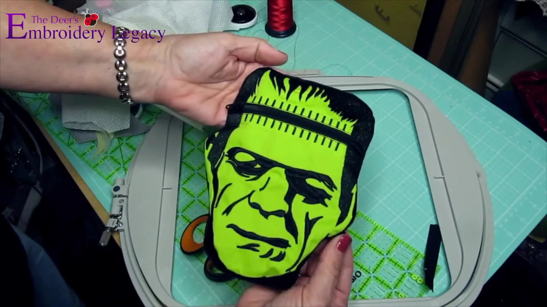 The finished Frankensac in-the-hoop zipper pouch is displayed upright, showing the stitched Frankenstein face and clean zipper finish.