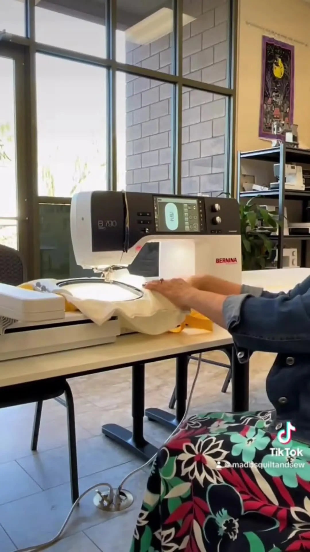 A yellow-handled tote bag is slid over the free arm of a Bernina embroidery machine, ready for the Large Freearm Hoop to be mounted.