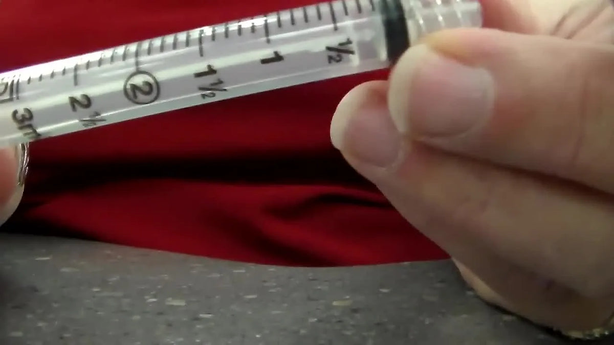 Zoomed-in view of syringe graduated markings and plunger.
