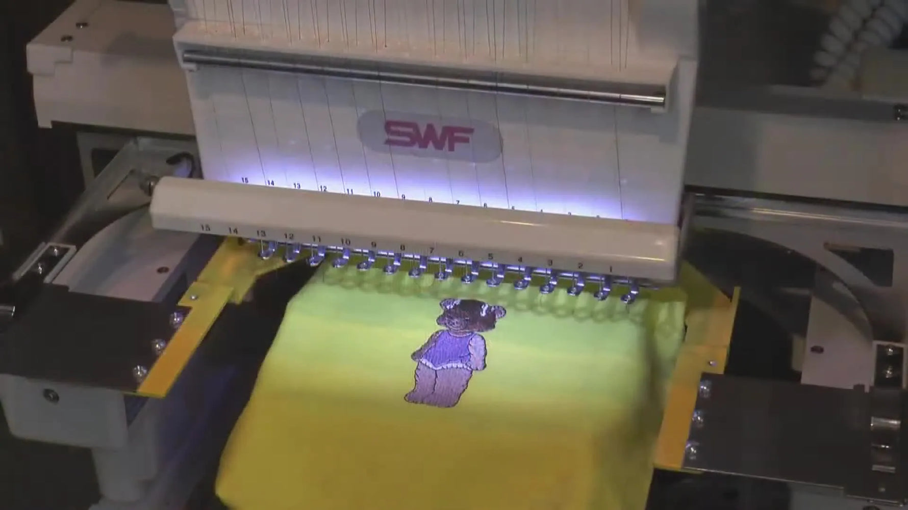 Embroidery machine with HoopTech clamp on a yellow item