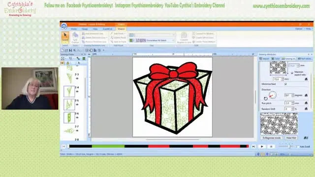 A close-up screen capture of a vector gift box in PE-DESIGN filled with a rotated Christmas truck decorative fill, showing the texture and the sewing attributes panel.