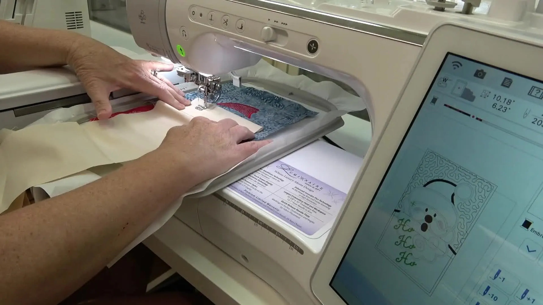 A close-up of changing to a 90/14 needle right before stitching metallic “Ho Ho Ho” on the Brother Luminaire.