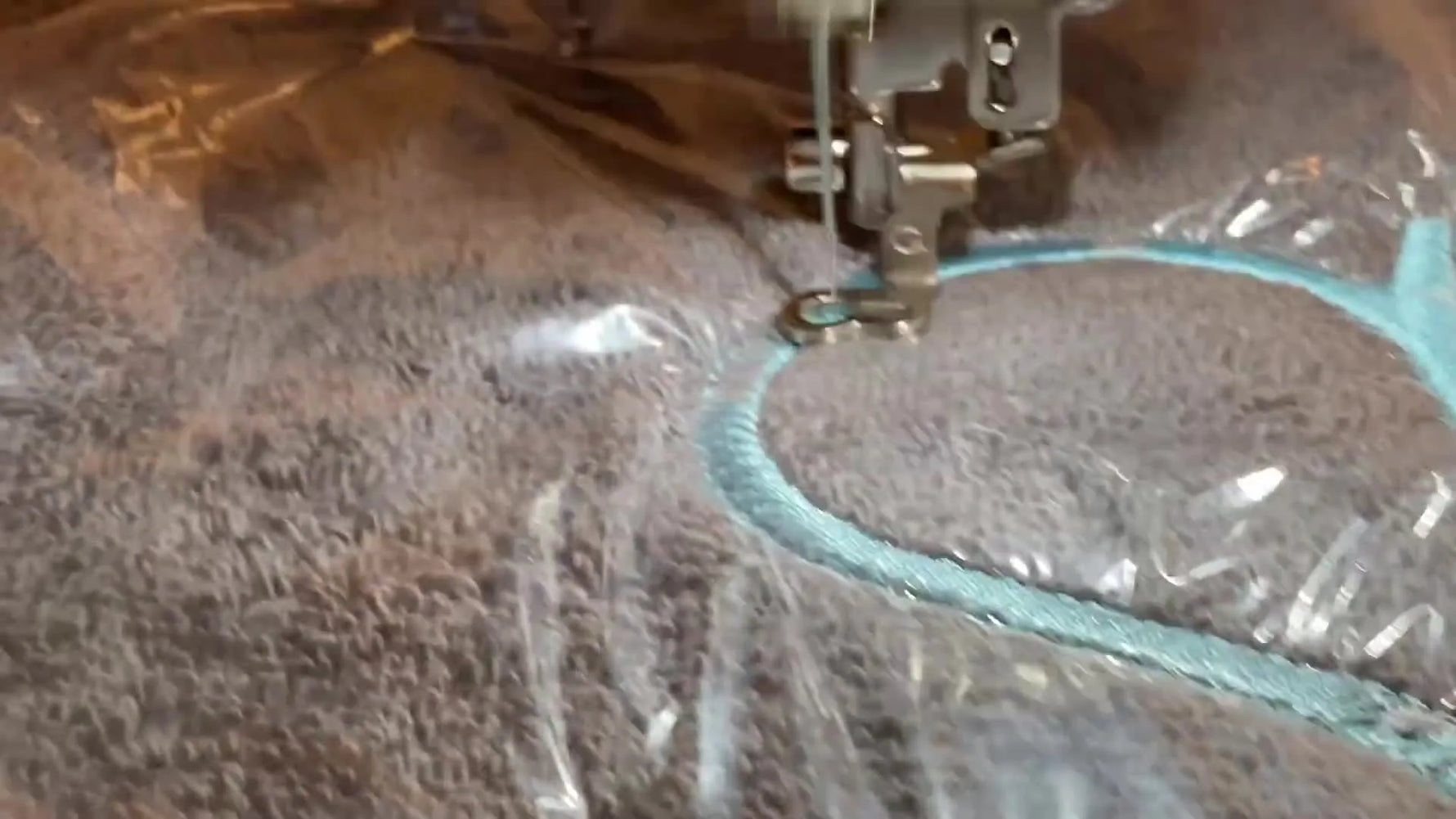 Scissors are used as a simple counterweight on an external thread stand to stabilize thread feeding during a Brother PE800 embroidery run.