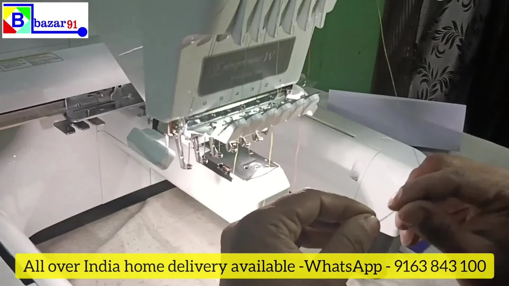 Brother PR680W embroidering a multi-colored bird design on white fabric.