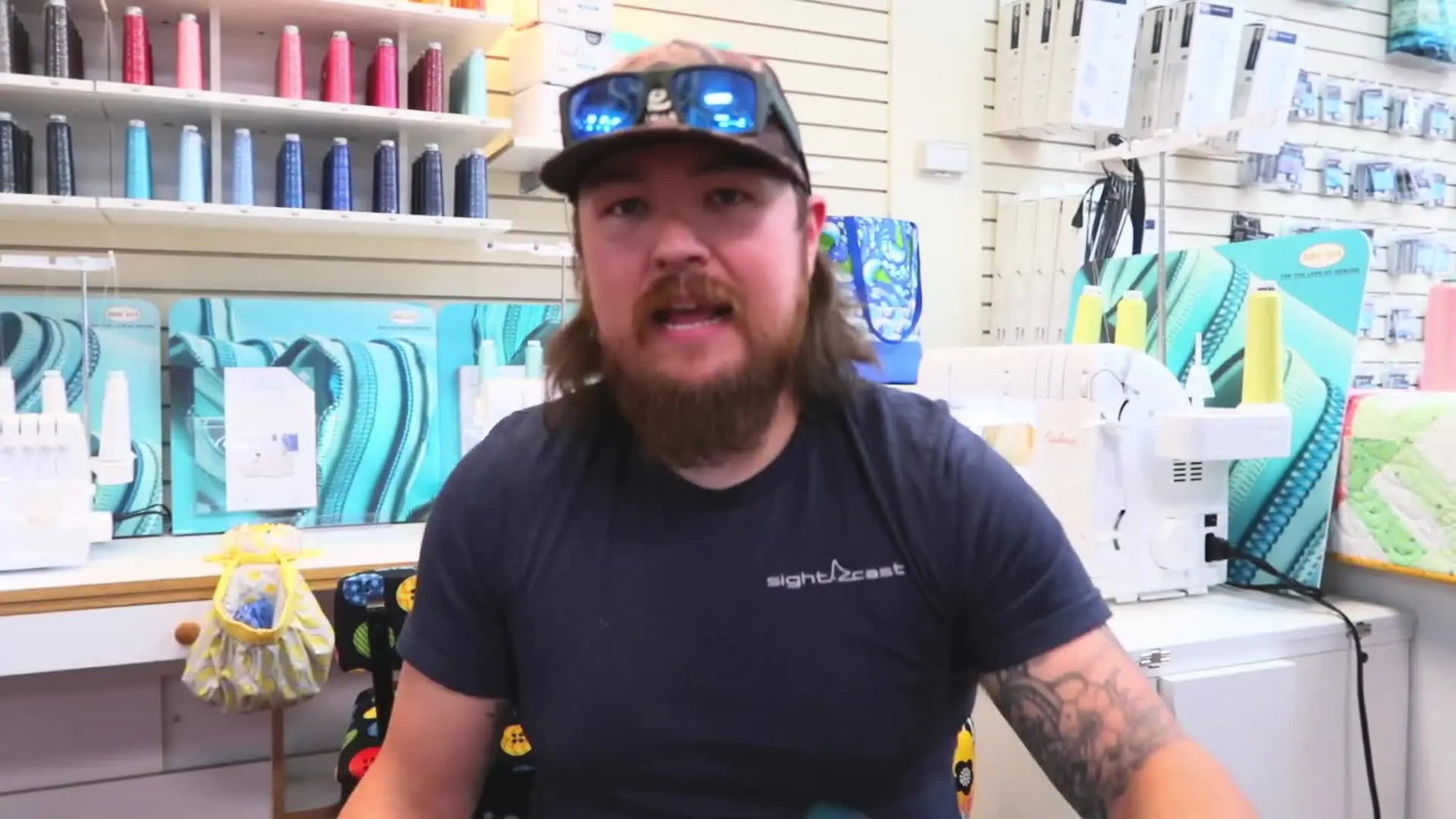 Jordan holds a teal magnetic hoop and shows how the top magnetic frame separates from the bottom metal frame for fast, consistent hooping.