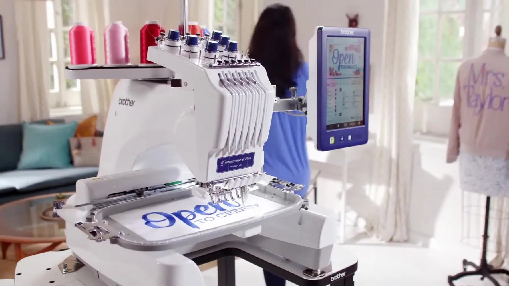 A wide studio shot of the Brother PR670E on a table, ready for multi-needle production work at home.