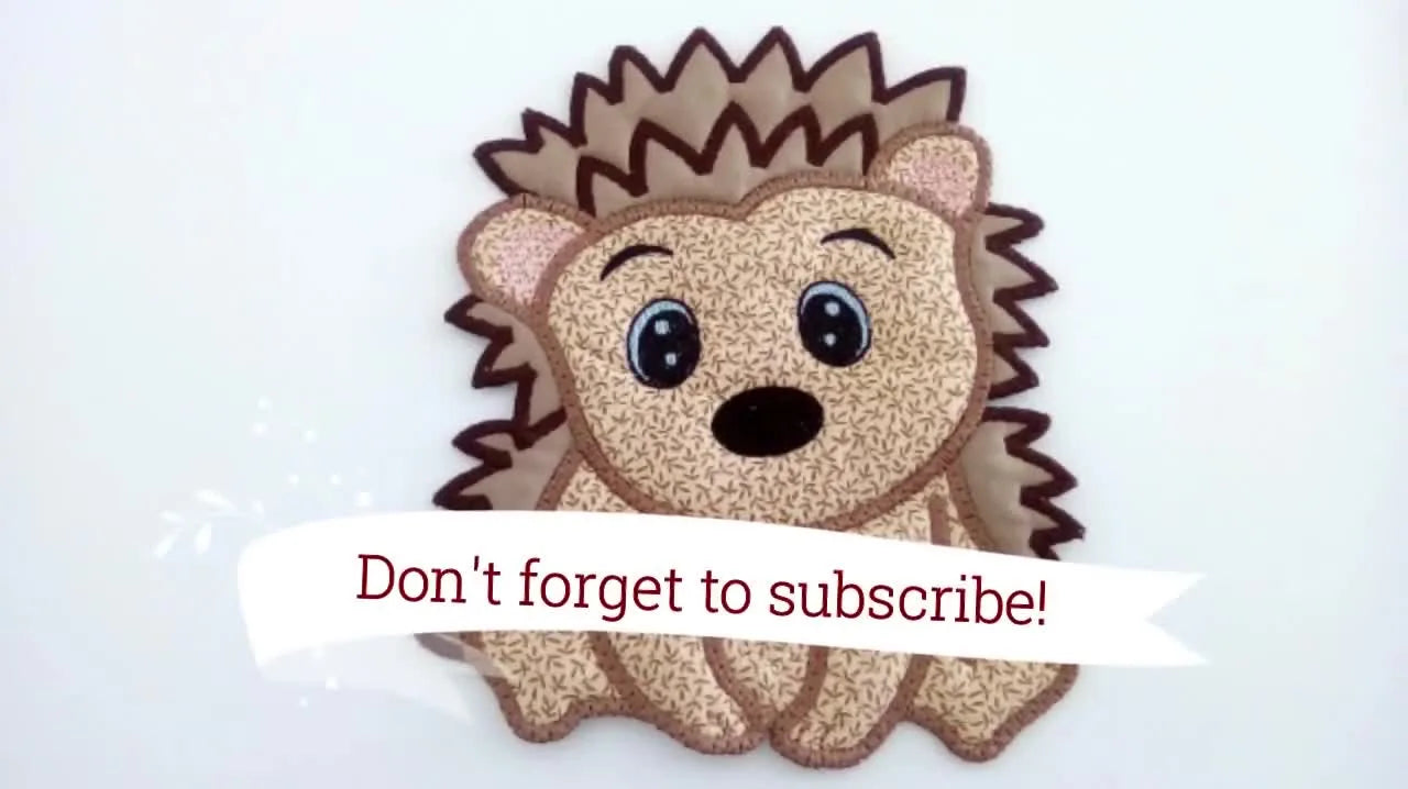 The finished large hedgehog applique is shown completed and neatly stitched, demonstrating how three hoopings can join into one oversized character.