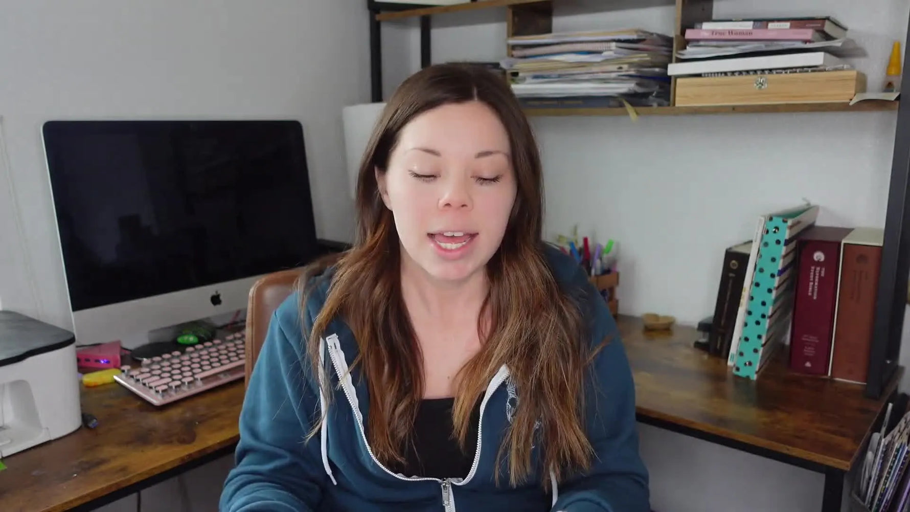 Speaker holding up a custom order form printed on white paper.
