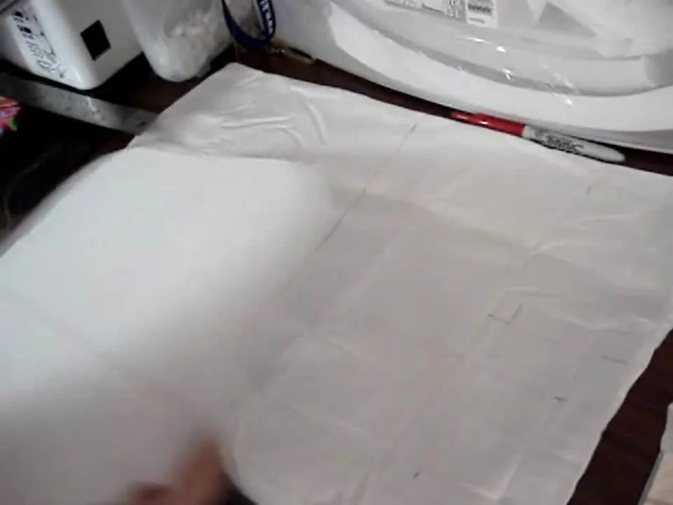A close-up shows a custom-cut flexible plastic hoop template used to align a pillowcase precisely for split-design embroidery.