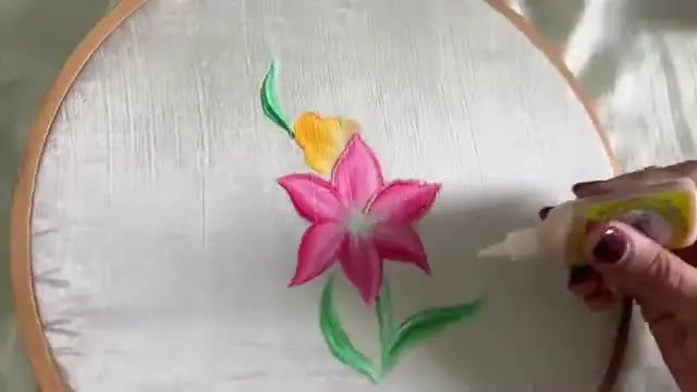 Applying a thin line of gold glitter 3D outliner along a leaf edge.