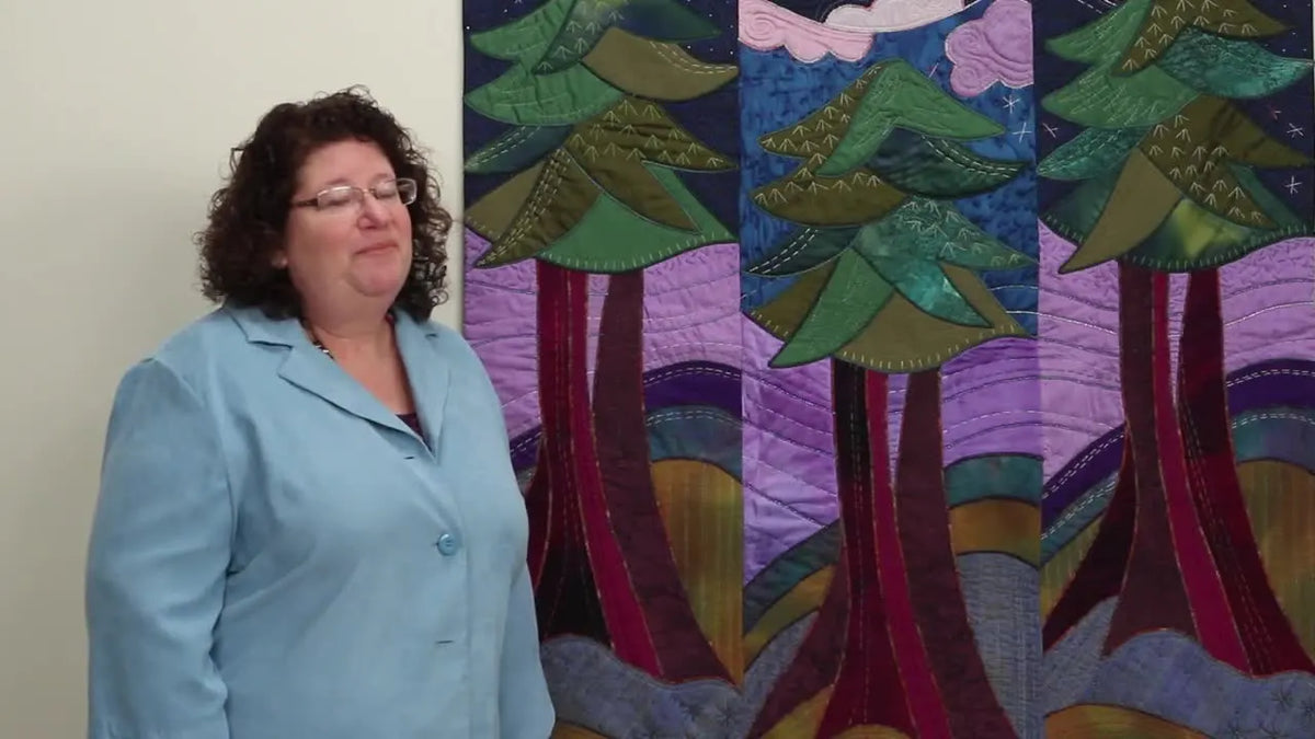 Rose Hughes with her vibrant quilt backdrop