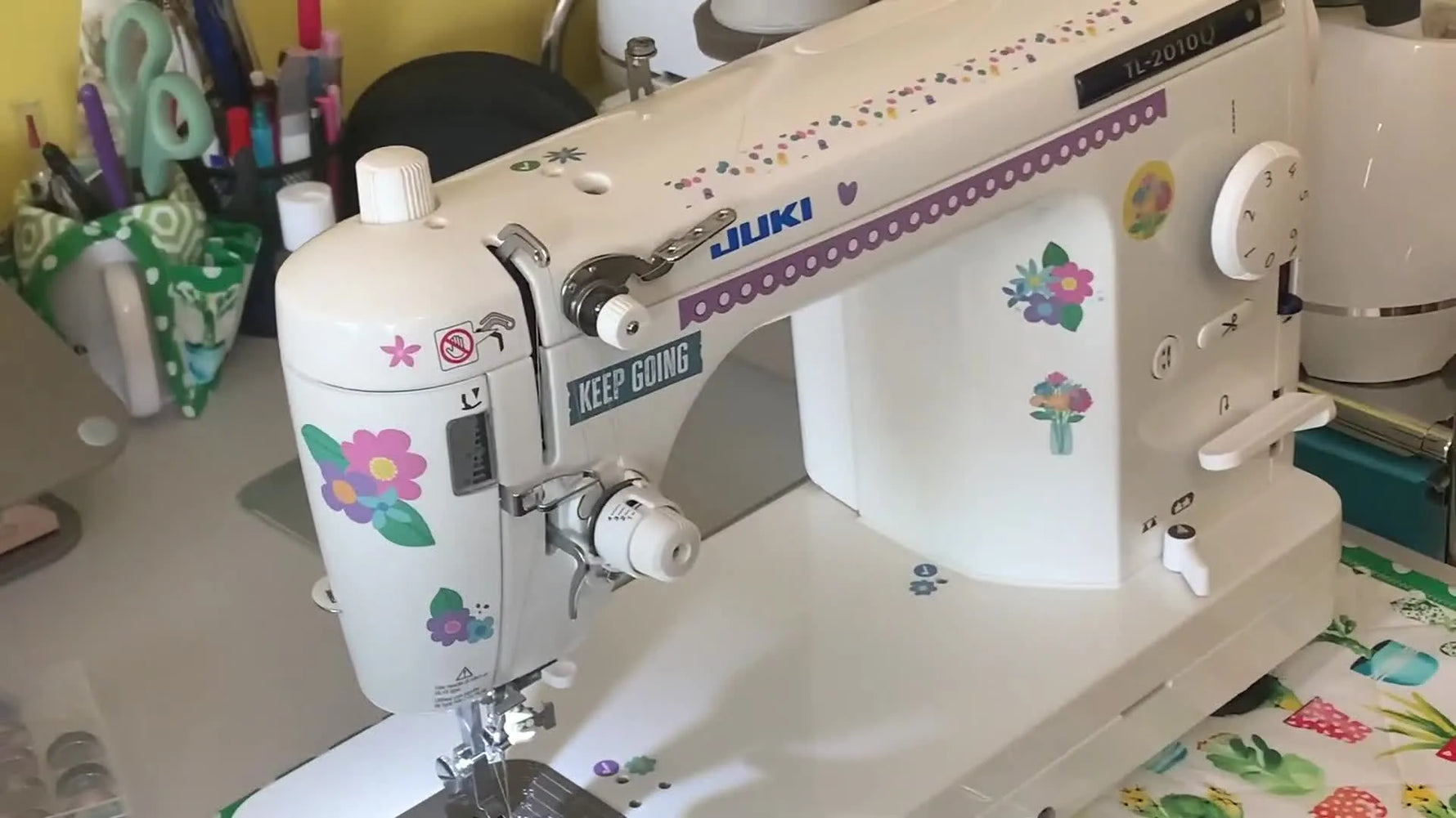 A wide shot of the Juki TL-2010Q setup used to topstitch a twill patch neatly over failed small-font embroidery.
