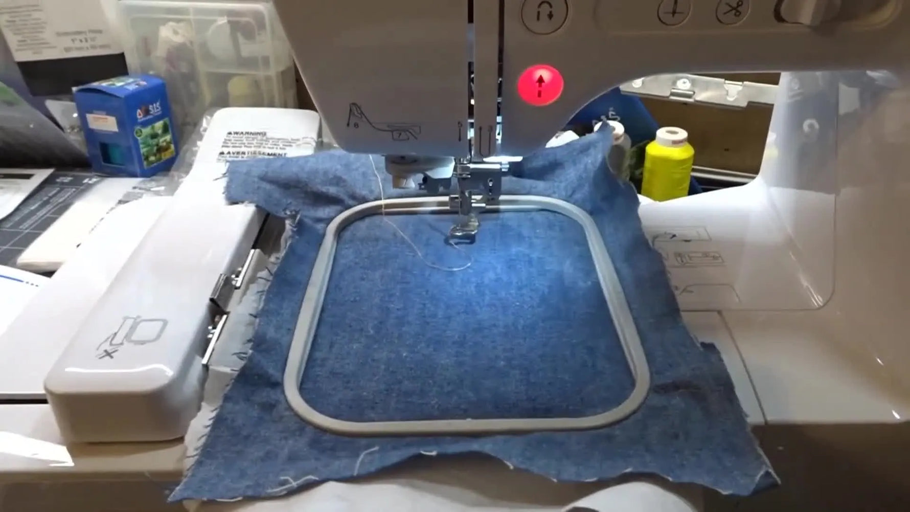 The Brother SE625 is actively stitching a built-in Christmas tree design on hooped denim during a first test run.
