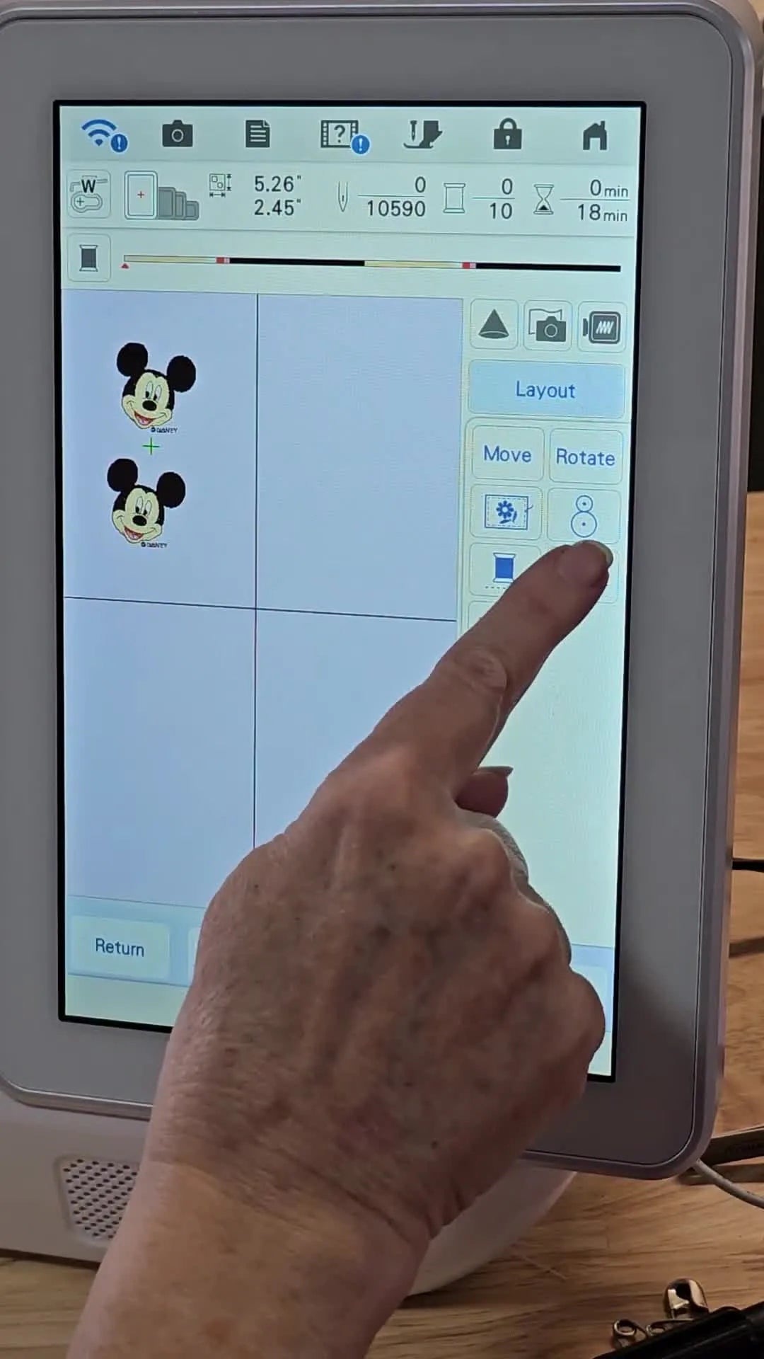 A close-up of the Brother Luminaire touchscreen highlighting the 3 Spools Color Sort icon being pressed.