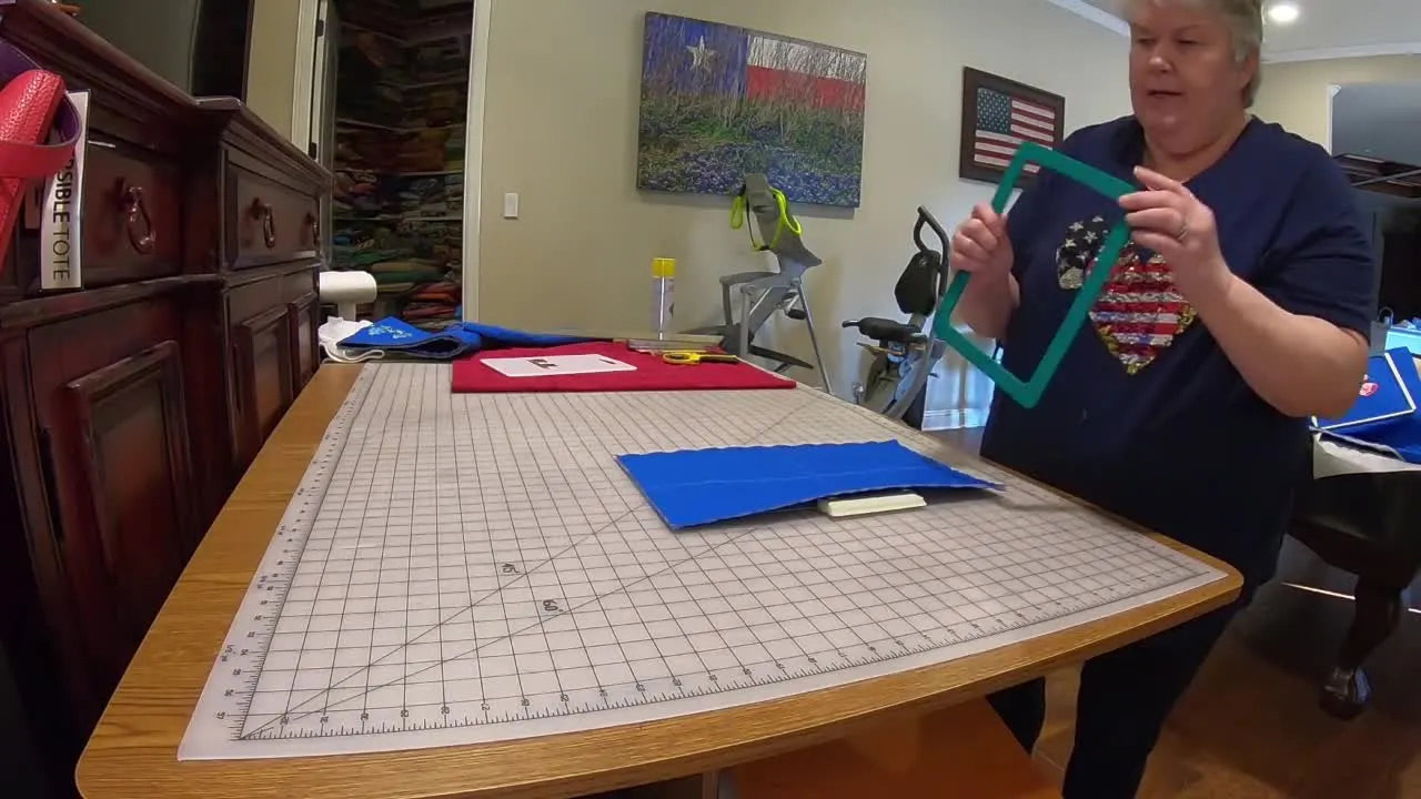 Hands snap the top magnetic frame onto the bottom frame, capturing the fabric cleanly and evenly for a straight, repeatable re-hoop.