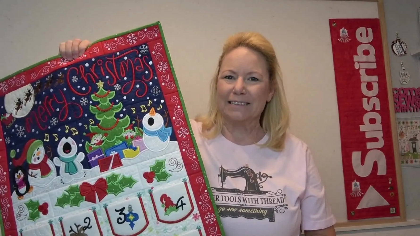 The host holds up the fully assembled and bound Whimsical Advent Calendar for the final reveal.