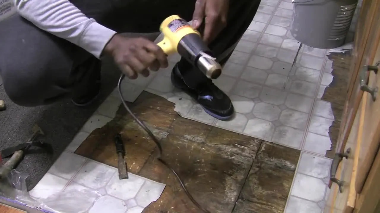 Man holding a yellow Wagner heat gun.