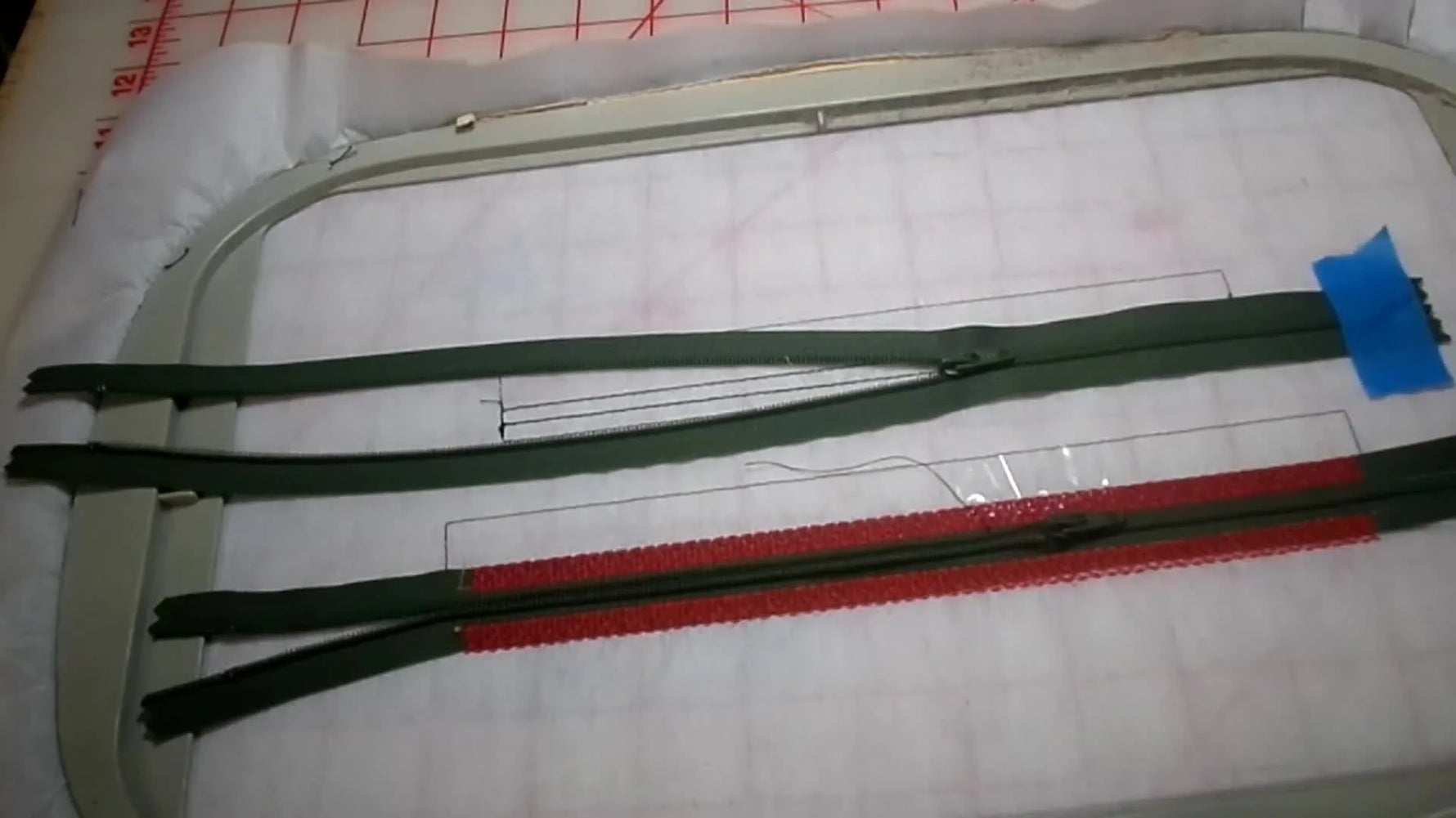 Close-up of a zipper being zipped while finger pressure keeps the teeth perfectly centered on the stitched placement line.