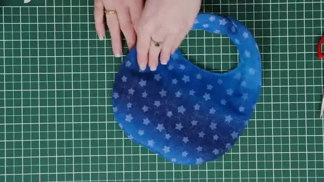An overhead showcase of the completed blue whale embroidered baby bib, neatly finished and ready to gift.