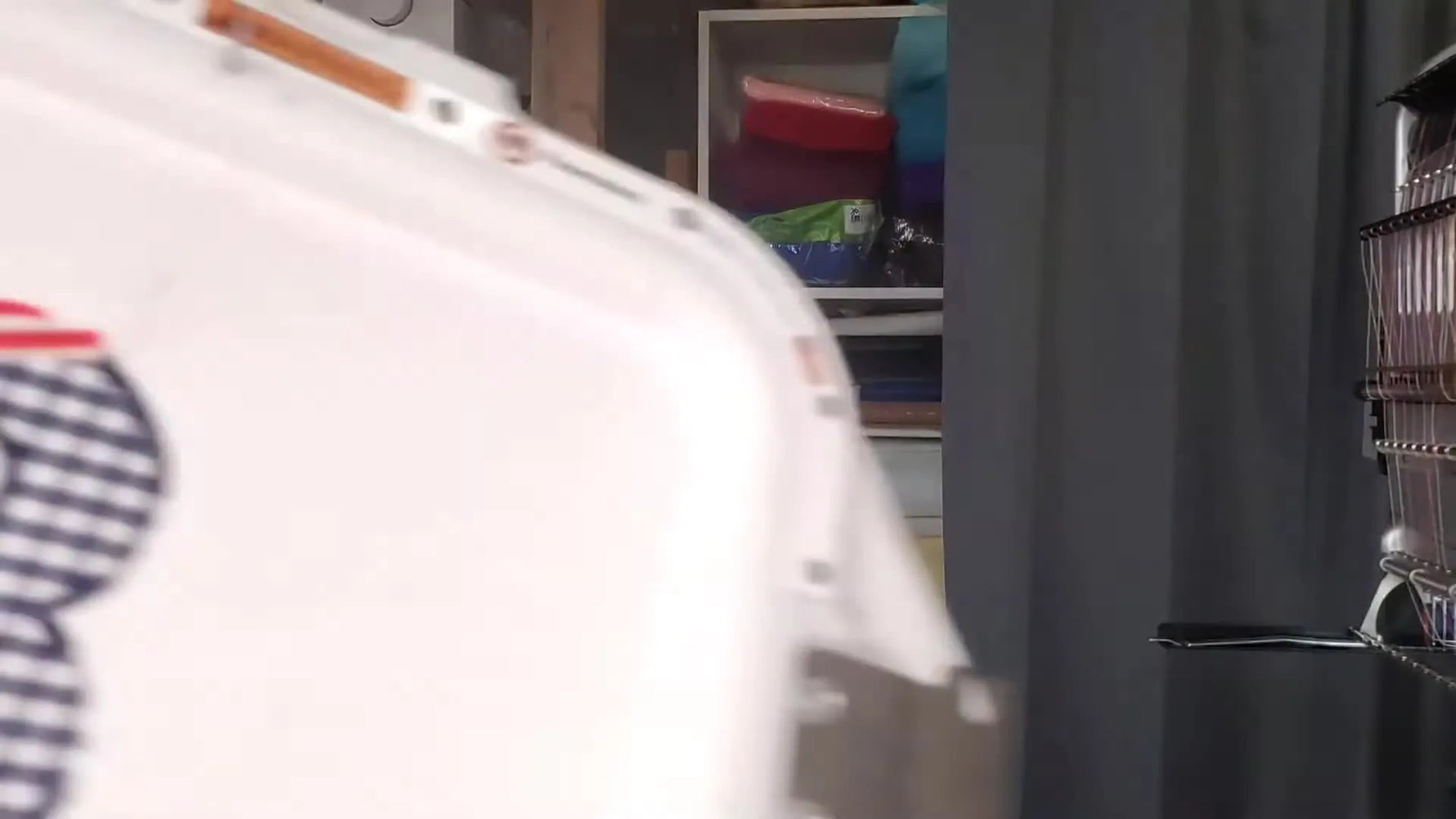 An extreme close-up shows a Melco needle trapped against the side of a Mighty Hoop magnetic frame, capturing the exact moment a hoop-placement mistake turns into a collision.