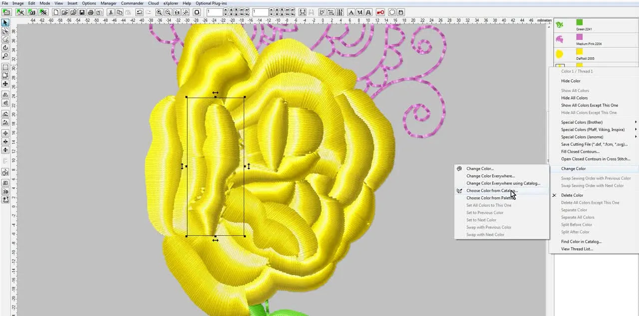 A screen capture of an Embird-edited rose design where one petal has been recolored to a warm orange/gold, showing the final multi-color result.