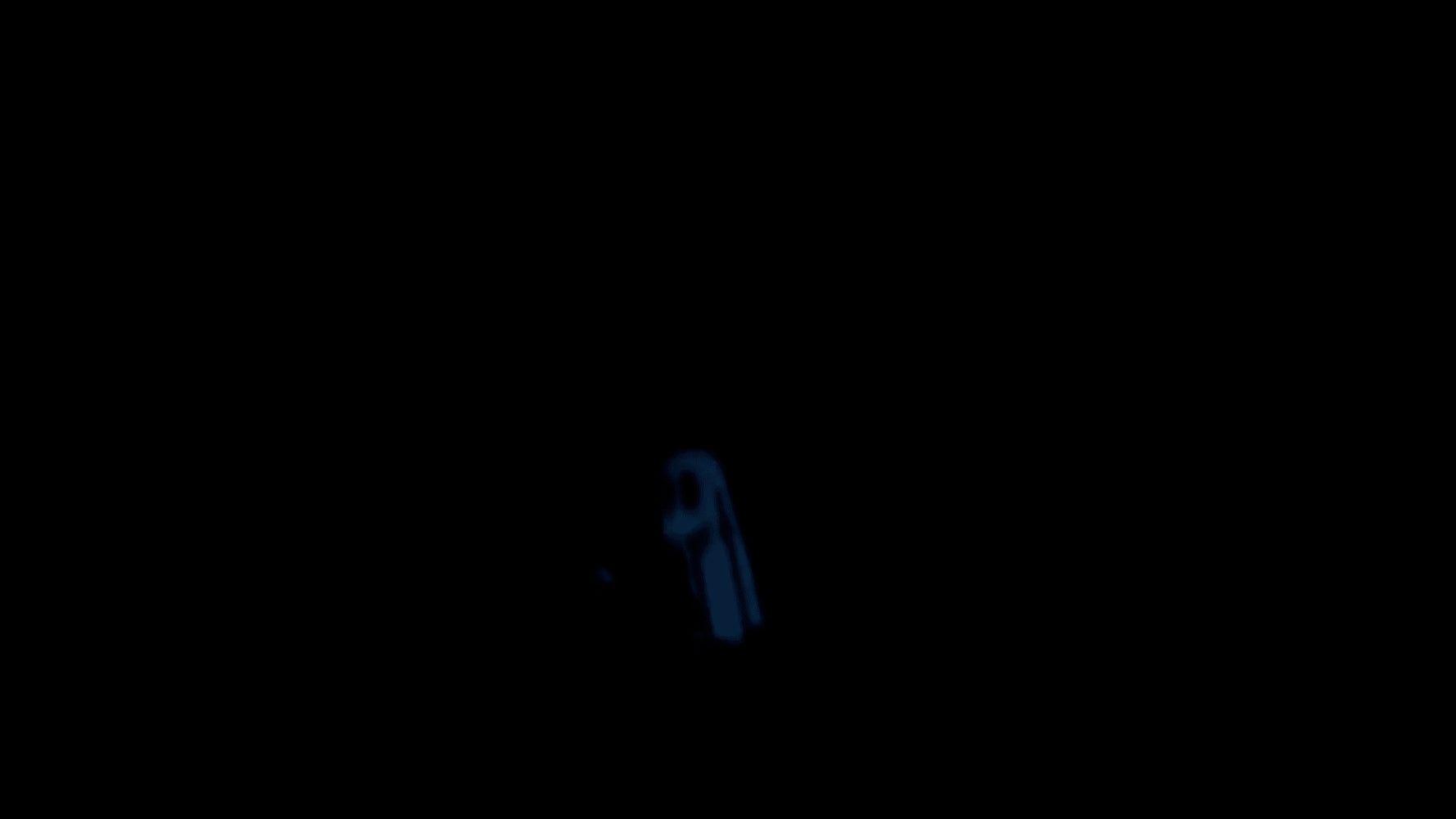 A finished ghost patch glowing bright blue against a dark background after the lights are turned off.