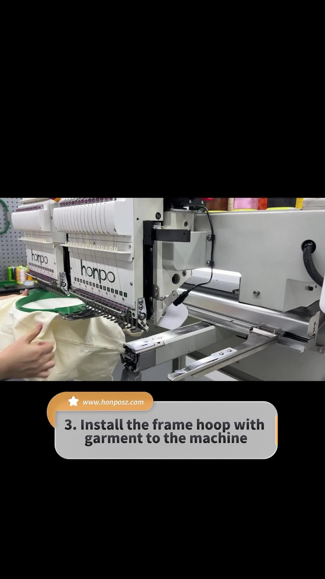A tubular hoop is fully installed on the Honpo machine with the tote bag fabric held taut and ready for stitching.
