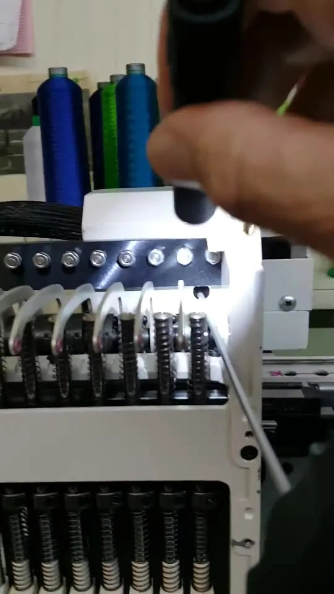 A flashlight illuminates the Tajima head’s side access hole while a T-handle hex wrench engages the internal adjustment screw.