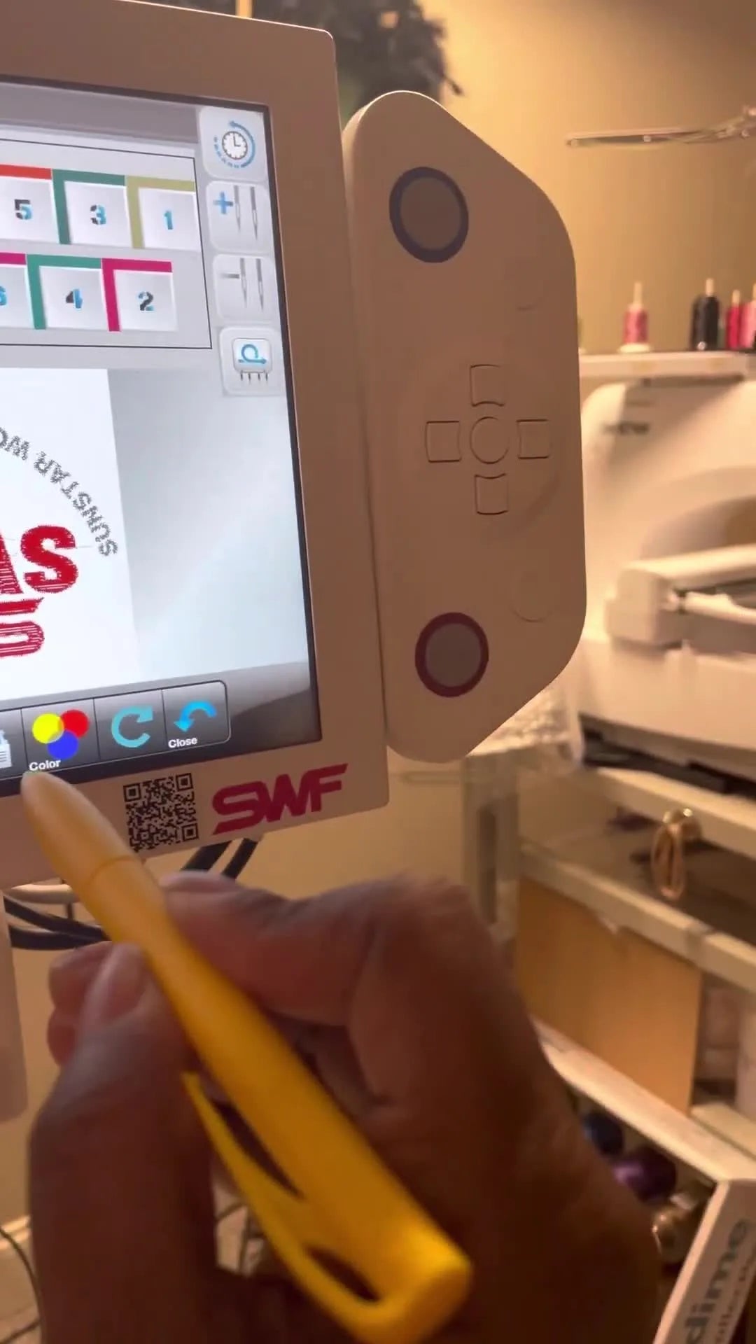 A close-up shows a yellow stylus selecting a color on the SWF MAS-15 touchscreen for accurate needle color assignment.