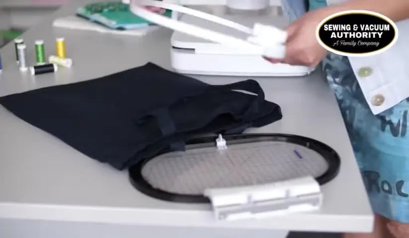 The grey outer Bernina Large Freearm Hoop is inserted inside a tote bag, demonstrating the inside-out hooping method for tubular embroidery.