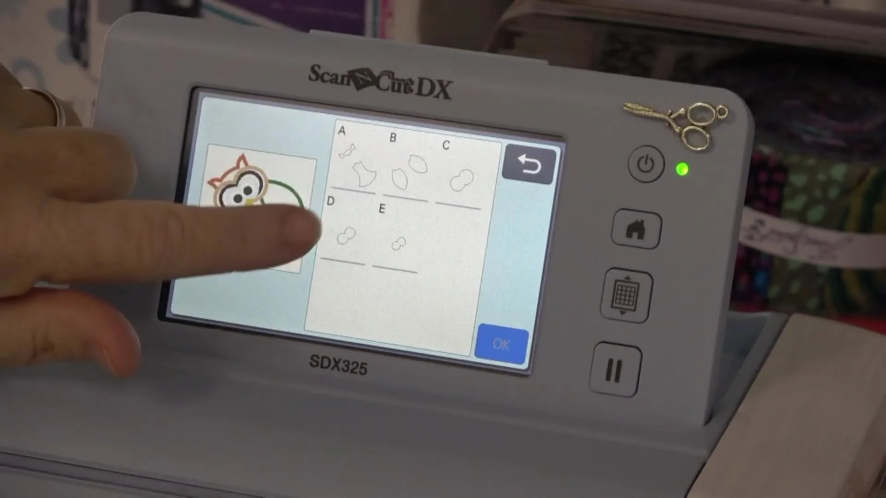 Close-up of the Brother Luminaire screen highlighting the scissors icon used to convert placement lines into appliqué cut data.