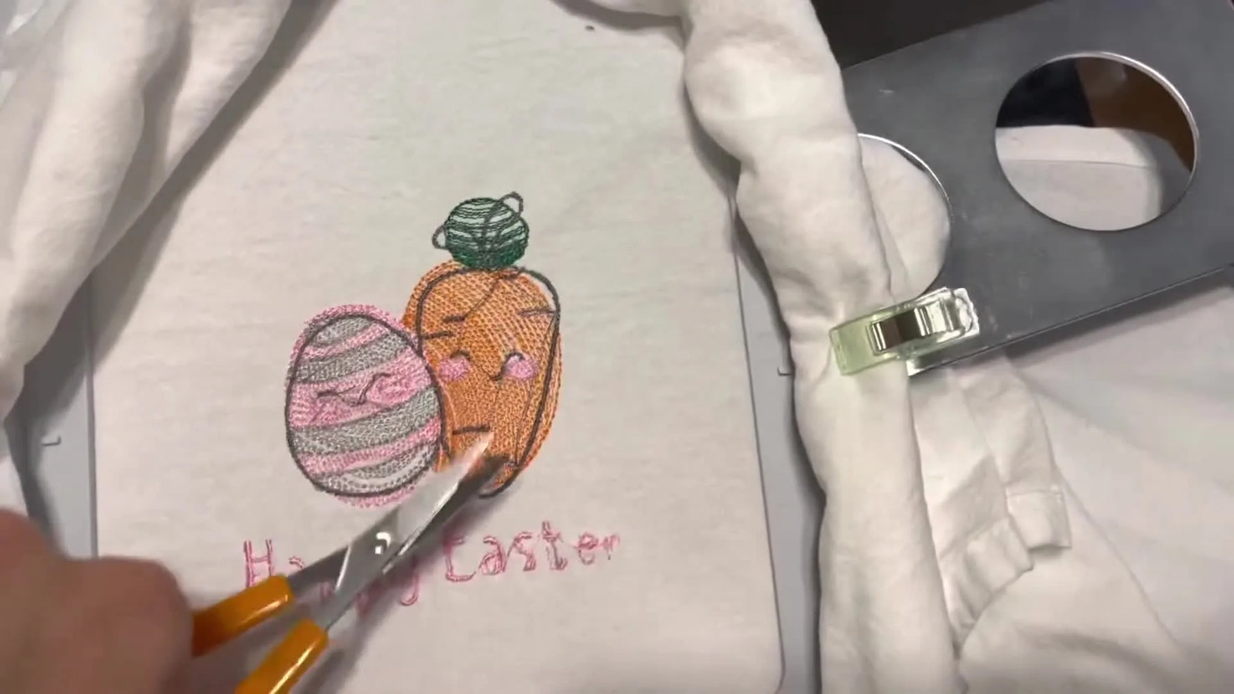 A finished yellow bunny sketch embroidery stitched on a white tea towel, shown as the final result from the Brother PE800.