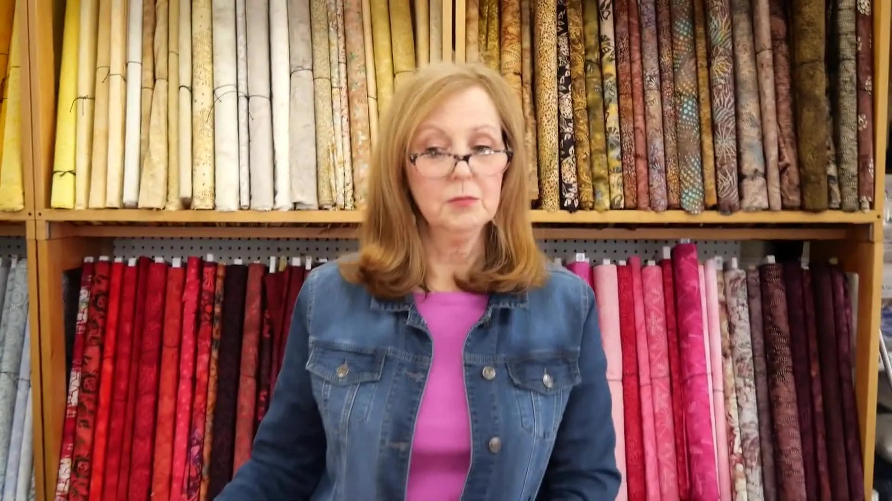 Elaine holds a Baby Lock–compatible magnetic embroidery hoop, showing the metal bottom frame and the magnetic top strips.