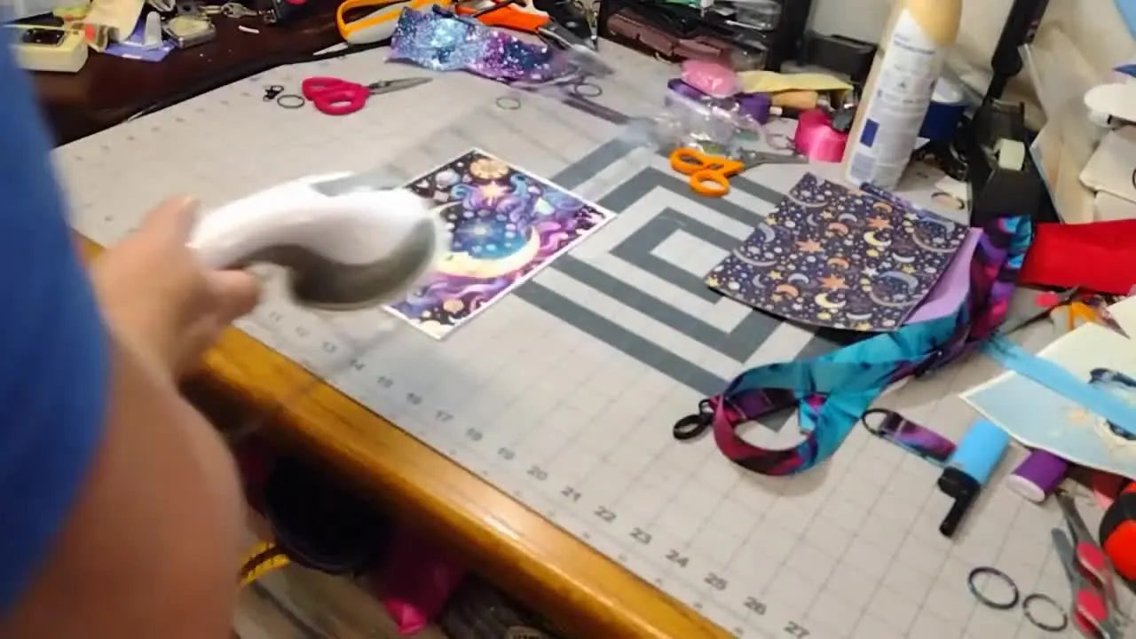 A multi-needle embroidery machine is shown with a magnetic hoop loaded and stabilizer held taut, ready for precise fabric placement.