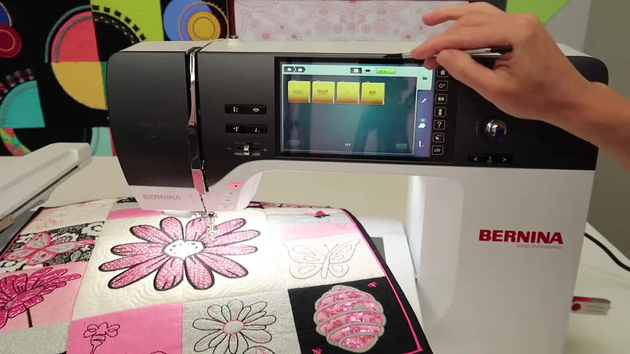 A stylus points to the USB icon on the Bernina 790 Pro screen, showing exactly where to tap to access designs on a USB stick.