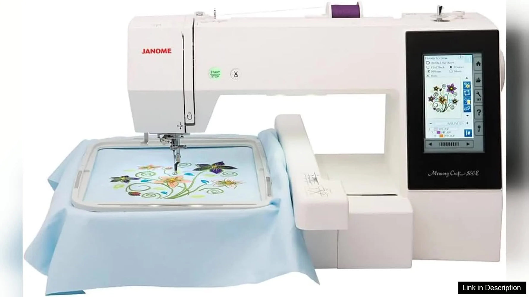 A full product view of the Janome Memory Craft 500E with the extension table and a large rectangular hoop mounted with a centered floral design.
