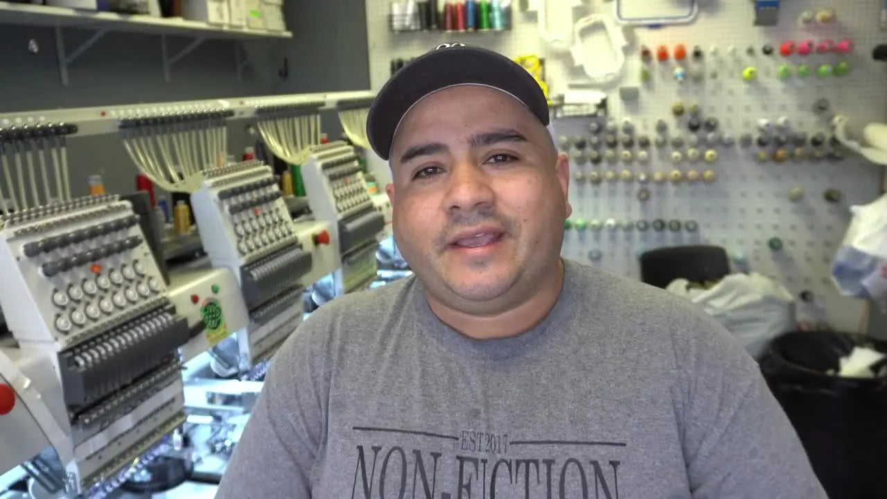 Presenter introduces a quick tip on V-neck embroidery in a workshop.