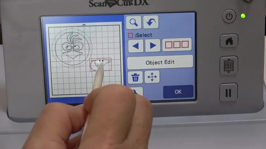 A close-up of the ScanNCut screen where the appliqué element is separated into placement, tack-down, and final stitch layers for clean cut-file creation.